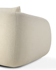 Close-up of the Figur Sofa | 2 seater by Ethnicraft—a modern beige upholstered piece with a rounded, minimalist design and textured fabric, shown against a white background—perfect for contemporary living.