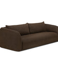 A contemporary, dark brown Figur Sofa | 3 Seater by Ethnicraft features rounded edges, minimalist design, thick armrests, and two large back cushions—perfect for elevating any modern living space with Ethnicraft’s signature style.