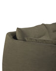 Close-up of the upper back corner of the Ethnicraft Weave Sofa | 2 Seater Green, highlighting its olive green, textured fabric upholstery and a slightly angled cushion for support. The background is white and uncluttered.