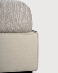Close-up of the Ethnicraft Revive Bed - Sand, showing its textured 100% linen cover and smooth, light-toned fabric frame against a plain background.