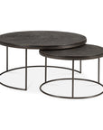 The Ethnicraft Nesting Coffee Table Slice Umber set features two round tables with dark wood tops and slim metal frames. The minimalist design allows the smaller table to partially nest under the larger one for versatile style.