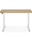 The Ethnicraft Bok Adjustable Desk - Oak features a light wood tabletop, white motorized adjustable metal legs for customizable height, and a round cable management hole in the back corner.
