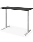The Ethnicraft Bok Adjustable Desk - Black Oak features a modern black oak tabletop, white metal legs, and built-in cable management, offering comfort and flexibility for both standing and sitting while you work.