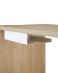 A close-up of a modern Ethnicraft wooden desk with a light wood finish, featuring a white horizontal shelf and an integrated Metal Cable Tray for organized cable management under the desktop.