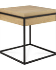 The Monolit Side Table - Oak and Black by Ethnicraft features a solid oak top and drawer with a minimalist black metal cube frame for a modern, stylish look.