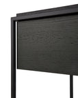 Close-up of the Ethnicraft Monolit Nightstand in black oak, featuring a rectangular metal frame and visible European oak grain that highlights its clean, minimalist lines and classic European craftsmanship.
