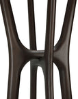 Close-up of intersecting dark brown stained mahogany legs on the Ethnicraft Pi Coat Stand, highlighting smooth finishes and organic, curved connections against a white background.
