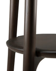Close-up of the Ethnicraft Pi Coat Stand in dark brown-stained mahogany, highlighting its rounded form and two smooth, cylindrical legs against a white background.