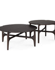 Two round Ethnicraft PI Coffee Tables in dark mahogany feature smooth surfaces, curved legs, and crossbars. Overlapping slightly, they highlight a modern minimalist aesthetic and exceptional craftsmanship.