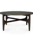The Ethnicraft PI Coffee Table - Mahogany features a round, dark mahogany top, smooth tapered legs, and a distinctive intersecting support structure beneath the tabletop.
