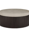 The Ethnicraft Roller Max Pouf combines modern minimalism with a light beige upholstered cushion and a dark, vertically slatted mahogany base.