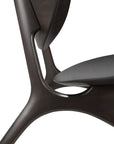 Close-up of the Ethnicraft Eye Lounge Chair in mahogany, featuring smooth, curved edges and an organic, sculptural design that highlights European refinement and sleek craftsmanship in the frame and seat.