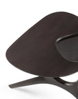 Close-up of the Ethnicraft Eye Lounge Chair in Mahogany, featuring smooth curves and a sculptural, abstract design on a white background—an elegant example of European refinement.