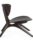 Side view of the Ethnicraft Eye Lounge Chair in mahogany, featuring smooth, curved lines, angled legs, and an upholstered seat and backrest for a sculptural, minimalist look against a white background.