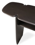 The Ethnicraft PI Console in mahogany features a modern design with a butterfly-shaped top, rounded edges, curved vertical legs, and a lower shelf. Only part of this elegant piece is visible in the image.