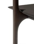 Close-up of the PI Rack - Mahogany by Ethnicraft, highlighting its modern dark wood finish, smooth curved lines, and seamless connection between the vertical leg and horizontal shelf.