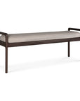 The Jack Bench by Ethnicraft features a dark brown mahogany frame, open rectangular arms, and an ivory upholstered seat cushion, reflecting Scandinavian modernism, shown against a white background.