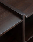Close-up of the Ethnicraft Mortise Rack showing an heirloom-quality dark wood mortise and tenon joint where the shelf meets the vertical support.
