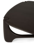 Close-up of the Ethnicraft PI Coffee Table in Mahogany, showcasing its pebble-shaped top, curved edges, and sculptural legs with a minimalist design.