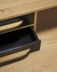 A close-up of Ethnicraft’s Origami Desk - Black highlights its classic European elegance, featuring black drawer fronts, an open empty drawer, and a light oak surface that exemplifies the brand’s timeless design.