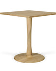 The Ethnicraft Torsion Square Dining Table - Oak is crafted from solid European oak with a central pedestal base, round flat bottom, and features a natural light finish for a simple, modern look.