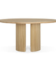 The Ethnicraft Roller Max Round Dining Table - Oak features a smooth top and two ribbed, semi-cylindrical pedestal legs, offering a modern minimalist look with a natural solid oak finish.