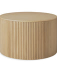 The Ethnicraft Roller Max Coffee Table - Oak features a round solid oak design with a smooth top, vertical slatted sides, and a light natural wood finish.