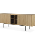 The Ethnicraft Roller Max Sideboard showcases grooved sliding doors, four central open shelves, and slim black metal legs. Crafted in a light natural wood finish, it blends modern design with the quality of solid oak.