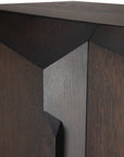 Close-up of the Ethnicraft Stairs cupboard in Oak Brown, showcasing its geometric, angular design with sharp edges, visible wood grain, and seamlessly integrated push-to-open doors that reflect fine craftsmanship.