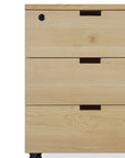 A close-up of the Ethnicraft Billy Drawer Unit in Oak shows its recessed handles, top lock, and soft-closing drawers; this three-drawer cabinet is set on wheels.