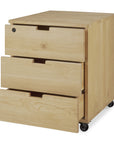 The Ethnicraft Billy Drawer Unit - Oak is a light solid oak piece with three drawers on black caster wheels, showing the top and bottom soft-closing drawers partially open while the middle drawer stays closed.