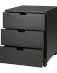 The Ethnicraft Billy Drawer Unit in black oak features three drawers (two open), casters for mobility, and a lockable top drawer.