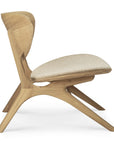 Side view of the Eye Lounge Chair - Oak with Off White Fabric by Ethnicraft, a modern solid oak seat featuring a curved backrest, angled legs, light off-white fabric cushion, and minimalist sculptural design.