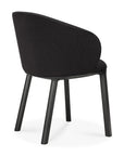 The Unda Dining Chair by Ethnicraft, designed by Studio Segers, features a modern black upholstered shell, curved backrest, and four straight legs, shown from the rear against a plain white background.