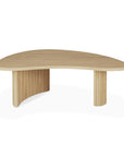The Ethnicraft Boomerang Coffee Table - Oak features a modern, organic kidney-shaped top and two rounded, vertical slatted legs, inspired by classic European design and photographed against a white background.