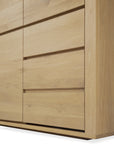 Close-up of the Ethnicraft Shadow Dresser in solid oak, showcasing a modern light finish, clean lines, and horizontal recessed handles.