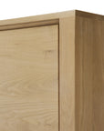 Close-up of the top corner of the Ethnicraft Shadow Dresser, highlighting its smooth solid oak surface, natural wood grain, and clean edges against a white background.