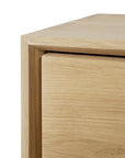 Close-up of the top corner of Ethnicraft's Nordic II Hanging Bedside Table, showcasing smooth, clean lines and natural solid European oak grain against a white background.