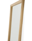 The Light Frame Floor Mirror - Oak by Ethnicraft is a tall, rectangular full-length mirror with a light solid oak frame, displayed from an angled side view against a plain white background.