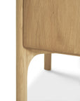Close-up of the solid oak leg and corner of the Ethnicraft Pi Sideboard - 3 door, highlighting its smooth, rounded edges and natural wood grain for a modern, minimalist look.