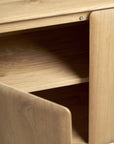 Close-up of the Ethnicraft Pi Sideboard - 3 door in light solid oak, showcasing its smooth natural finish, modern minimalist design, and interior shelves behind the open door.