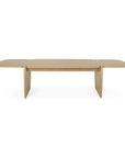 The Ethnicraft PI Coffee Table - Oak is a modern, minimalistic table crafted from solid oak with rounded edges and wide flat end legs, featuring a light wood finish and contemporary rectangular design.