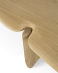 Close-up of the Ethnicraft PI Console - Oak, highlighting its smooth, rounded edges and distinctive curved joint at the leg-tabletop connection, exemplifying modern minimalism.