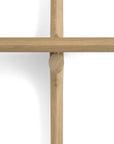 A top-down view of Ethnicraft’s PI Wall Shelf - Oak (2 shelves) shows three handcrafted light oak rods crossing on a white background, with one solid oak rod vertical and two placed horizontally.