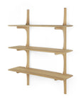 The Ethnicraft PI Wall Shelf - Oak (3 shelves) features smooth, rounded edges and curved supports in solid oak. This minimalist piece from the PI collection is mounted against a white background.