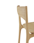 A close-up of the Ethnicraft PI Dining Chair - Oak showcases its smooth, natural finish on the back and seat, set against a plain white background.