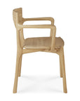 Side view of the Ethnicraft PI Dining Chair - Oak with arms, featuring a curved backrest, armrests, and a smooth solid oak seat. The design highlights rounded edges and embodies a minimalist style.