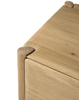 Close-up of the Ethnicraft PI TV Cupboard corner in solid oak, highlighting its rounded edges and smooth, minimalist design against a white background.
