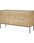 The Ethnicraft Whitebird Sideboard - 3 door is a modern, minimalist piece crafted from solid oak with three flat front doors and black metal legs, shown against a white background.