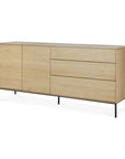 The Ethnicraft Whitebird Sideboard - 71 features clean lines, solid oak in a light finish, two left doors, three right drawers, and black metal legs for a modern look.